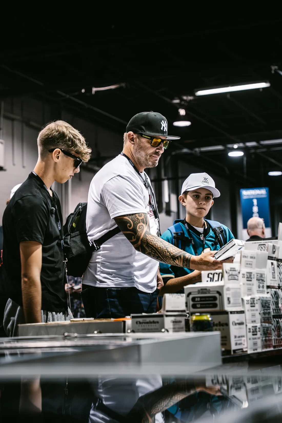 Ryan and his sons on a card show floor